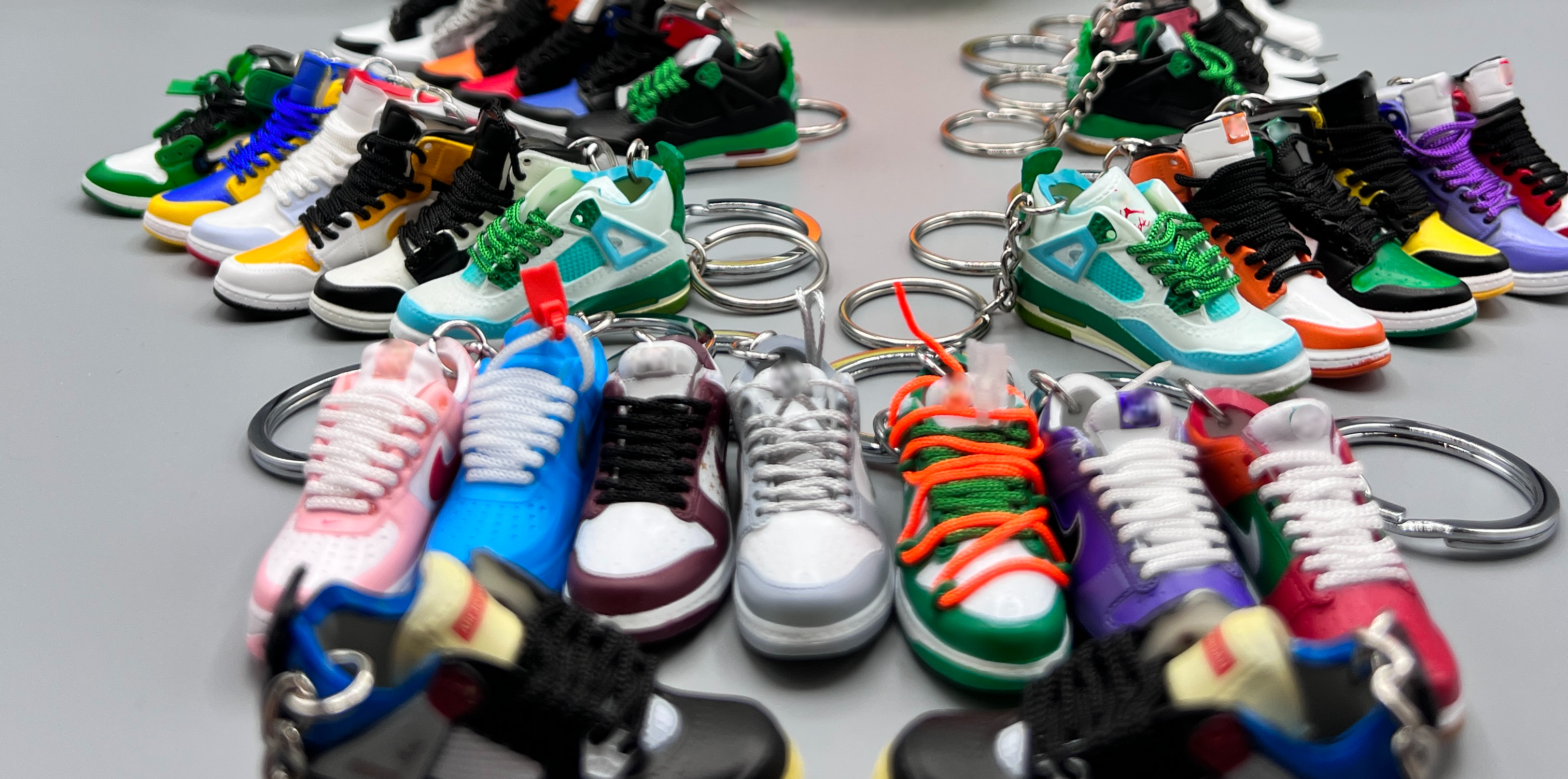 Collection of colorful shoe keychains on a gray background