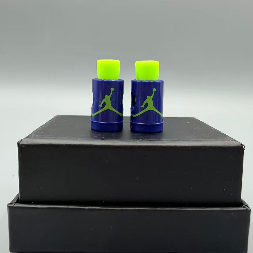 Two blue and green lace locks on a black box with a gray background