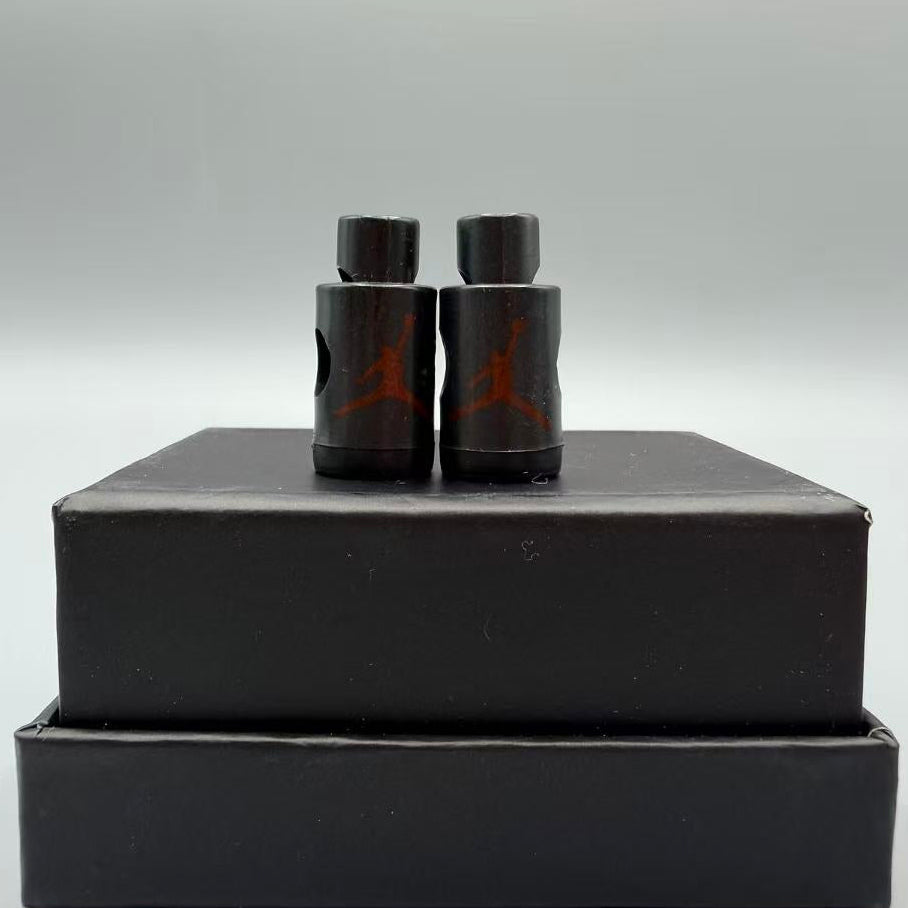 Black lacelocks with red logo on a black box against a gray background