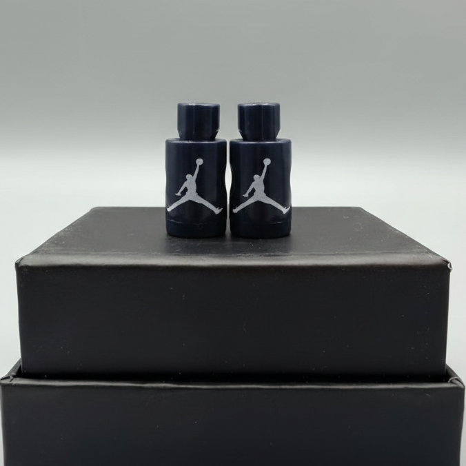 Navy Blue Jordan Lace locks with white logo on a black box against a gray background
